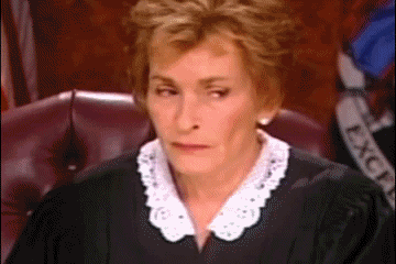 Judge Judy sighing and putting her head in her hands
