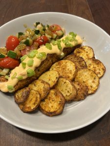 Blue Apron salmon dinner with zucchinis and tomatoes and side of potatoes