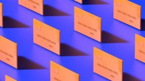 Orange credit cards on a solid purple background