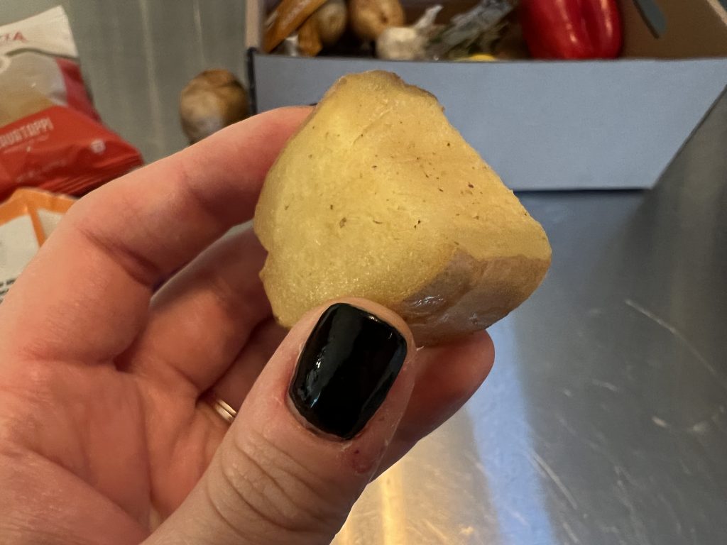 Holding piece of rotting ginger root