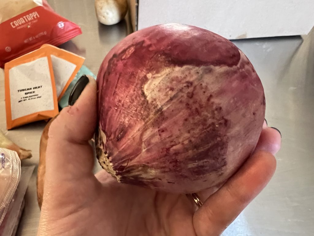 Holding discolored red onion