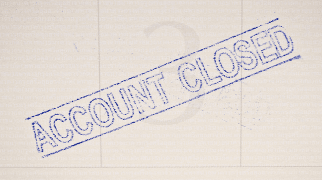 Stamp of account closed in blue ink on tan background