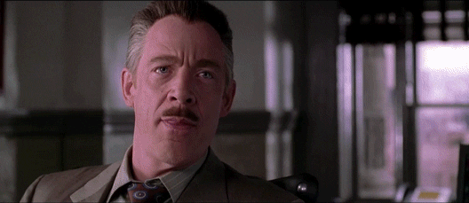 Fictional character J. Jonah Jameson dressed in a suit laughing hysterically