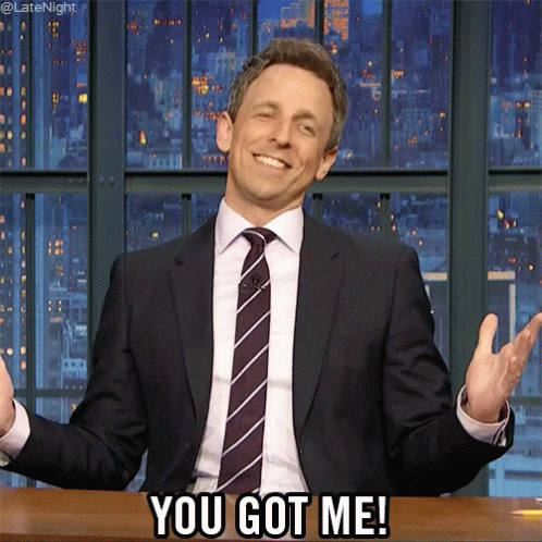 Comedian Seth Myers throwing his hands up, saying "You got me!"