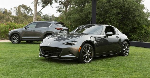 Mazda cars parked on grass