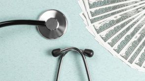 A stethoscope and fan of $100 bills