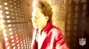 Singer The Weeknd walking through a maze of lights