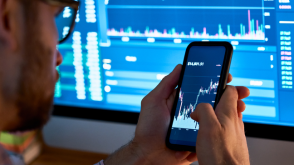 Man checking the value of a cryptocurrency on his phone