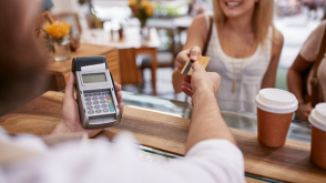 Cap One SavorOne for Good Credit review Woman making a purchase with her credit card at a store