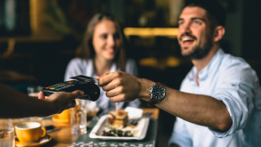 Couple using a credit card to purchase food at a restaurant