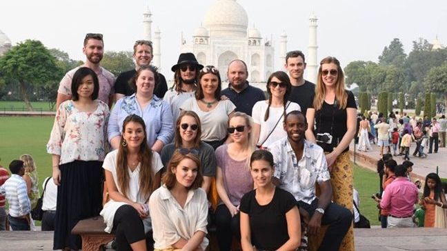 Group of travellers in front of the Taj Mahal in India