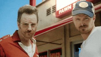 A gif of two men in front of a pawn shop, high-fiving and chest bumping