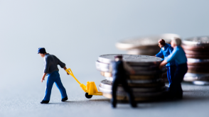 Figurines of a man pulling coins away from others trying to hold onto them