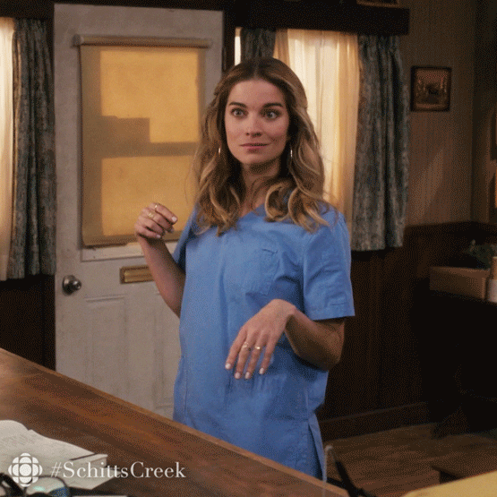 GIF of a woman making an intrigued gesture