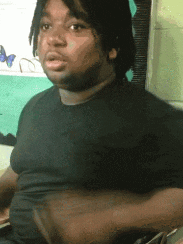 A gif of a young man making the peace sign and then fading away.