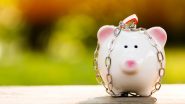 A piggy bank with a chain wrapped around it and a padlock on its head.
