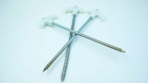 Three metal stakes piled atop one another.