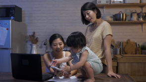 LGBT estate planning Two women play with their daughter indoors