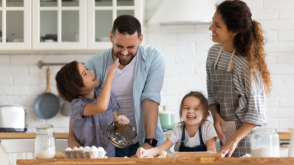 A young family making a mess in the kitchen