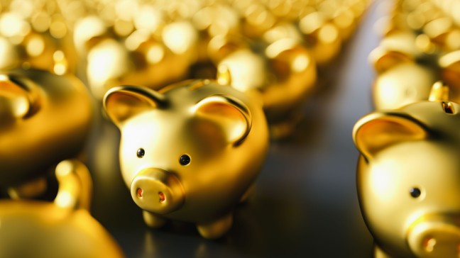 A number of golden piggy banks lined up