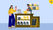 Young adult buying coffee with a credit card