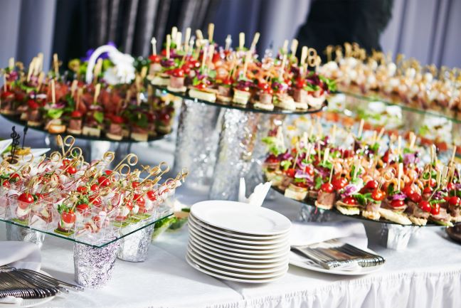 Appetizers on trays and stands at wedding