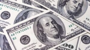 collage of hundred dollar bills