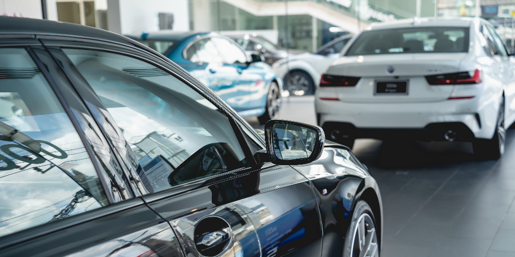 New BMWs in a car dealership showroom.