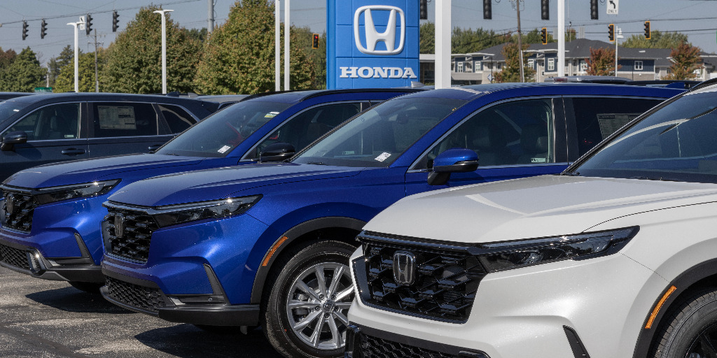 A photo of new Honda CRVs on a dealership lot. From "Is it better to finance a car or pay cash?"