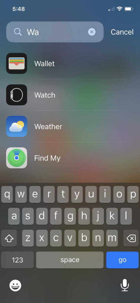 A screenshot of how to search for the Wallet app on an iphone.
