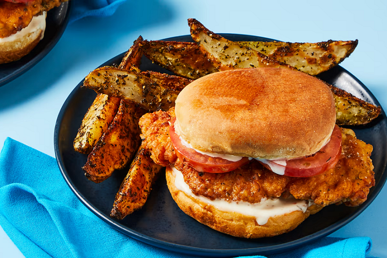 Photograph of Italian crispy chicken sandwich with herb potato wedges from EveryPlate.