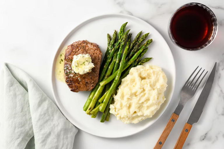 Photograph of herb butter filet mignon with mashed potatoes and asparagus from Home Chef.