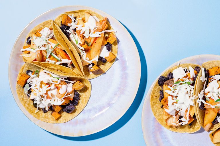Photograph of sweet potato black bean tacos with peach kimchi and citrus aioli from Purple Carrot.