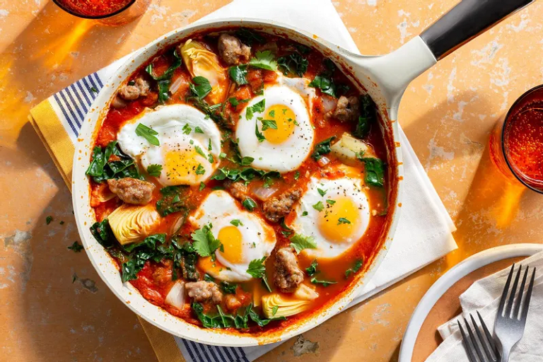 Photograph of sausage shakshuka with eggs, artichoke hearts, and kale from Sunbasket.