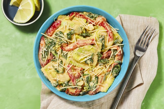 Photo of prepared chicken and spinach ricotta ravioli with bell pepper and parmesan from a HelloFresh meal kit.