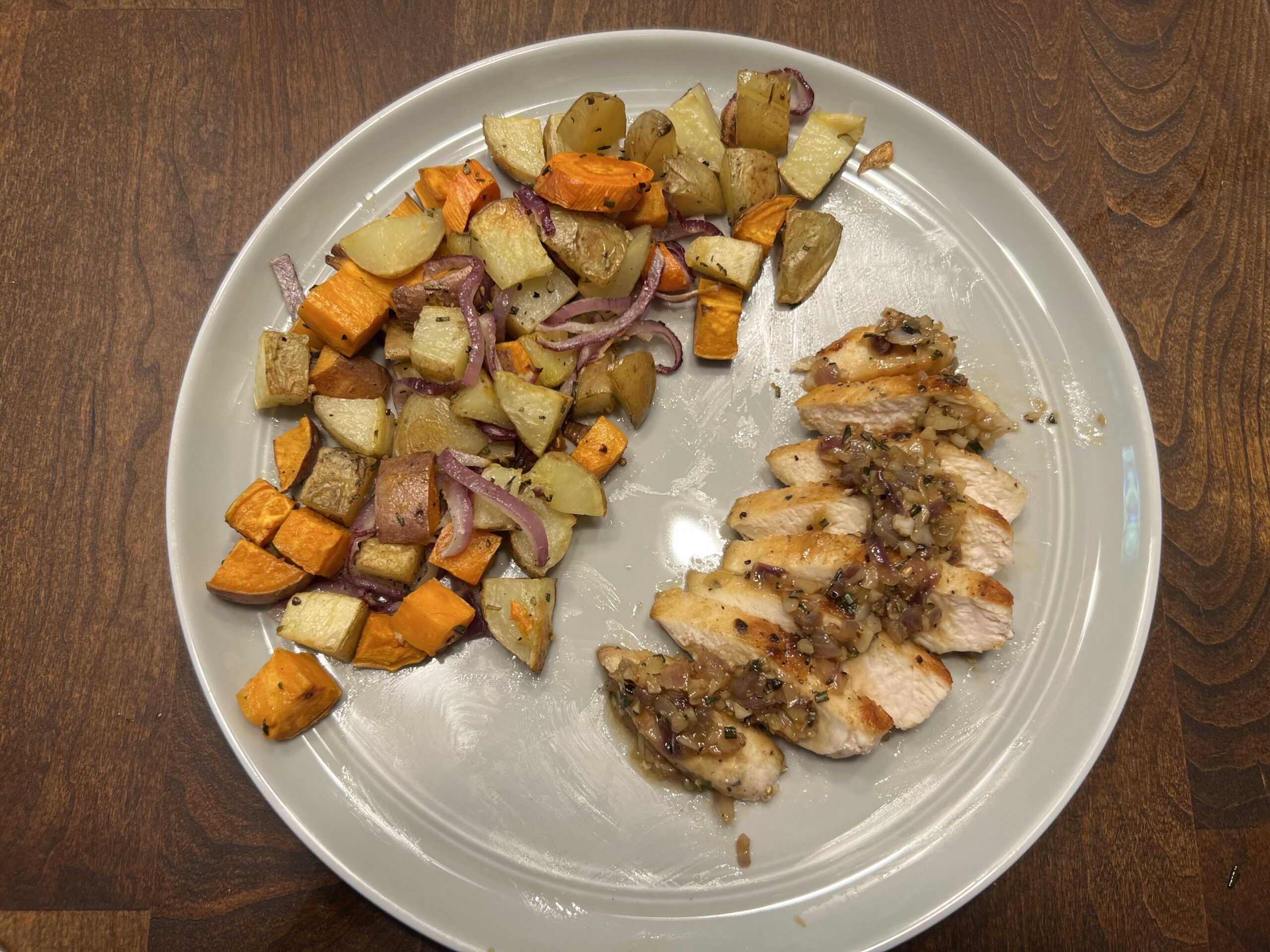 Prepared meal of garlic rosemary chicken with roasted root vegetables from EveryPlate