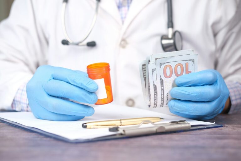 person holding orange and white plastic bottle; medical debt credit report