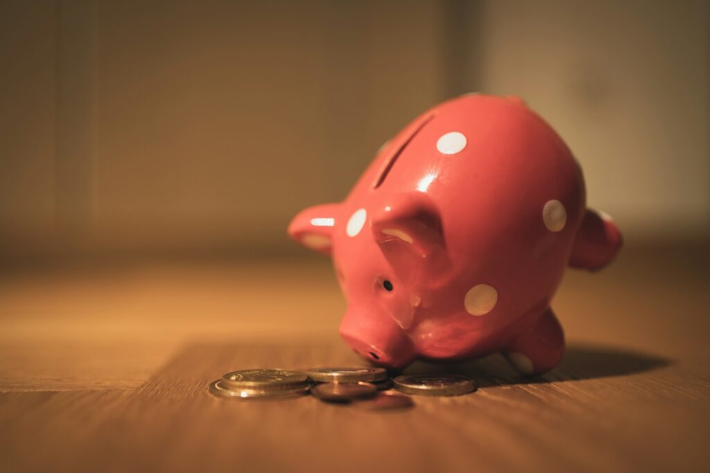 pink pig coin bank on brown wooden table; best high yield savings accounts
