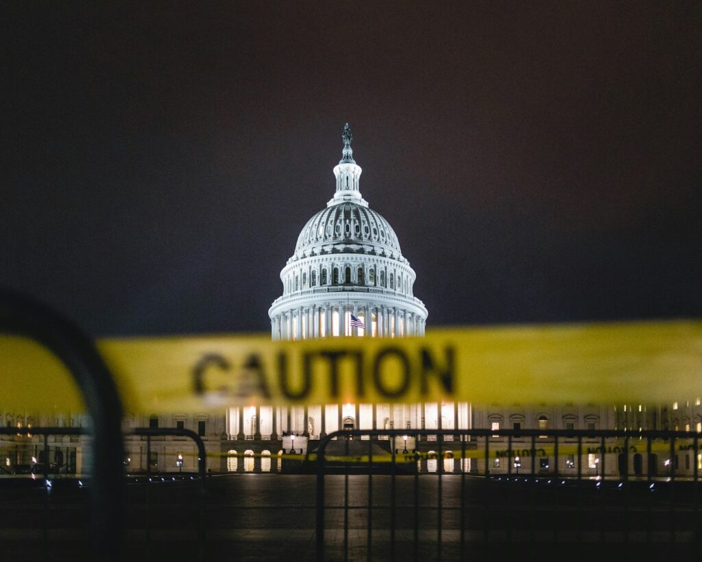 white concrete building at nighttime; CFPB shutdown