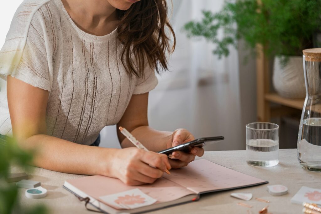 a woman writing on a piece of paper; Holiday budget