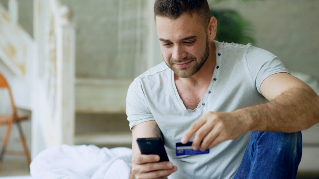 Young adult checking multiple buy now pay later payment due dates on a phone; BNPL late payments