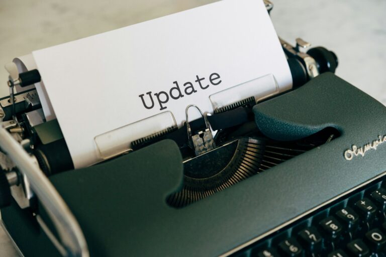 white printer paper on green typewriter; tax withholding update