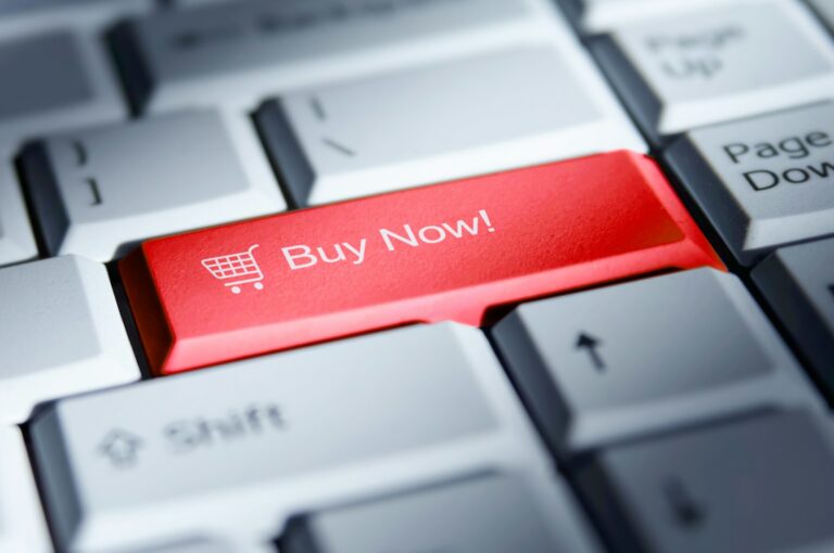 Red 'buy now!' button on a computer keyboard; buy now pay later