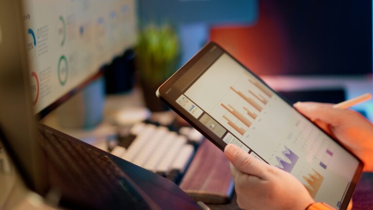 Someone analyzes financial data on a tablet.;understanding website traffic