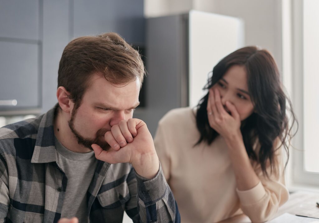 Couple having a serious conversation about falling behind on debt payments