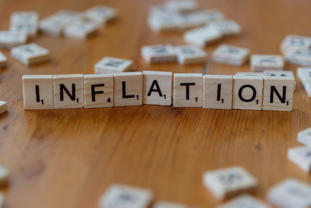 Inflation is spelled out using scrabble tiles; September inflation report