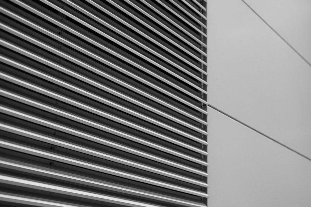 a black and white photo of the side of a building; coil