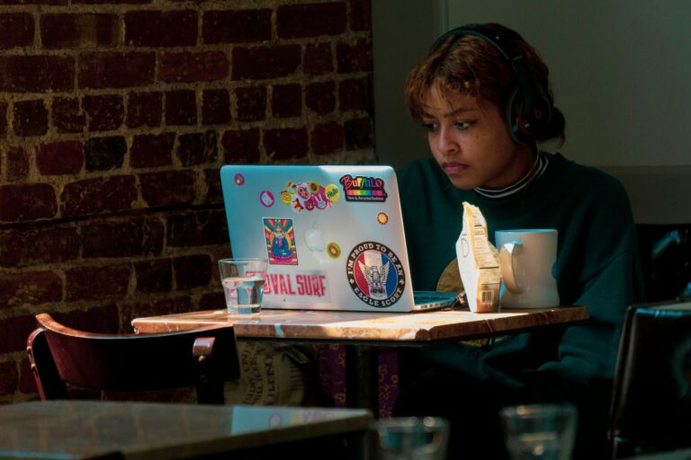 a woman sitting in front of a laptop computer; SAVE plan