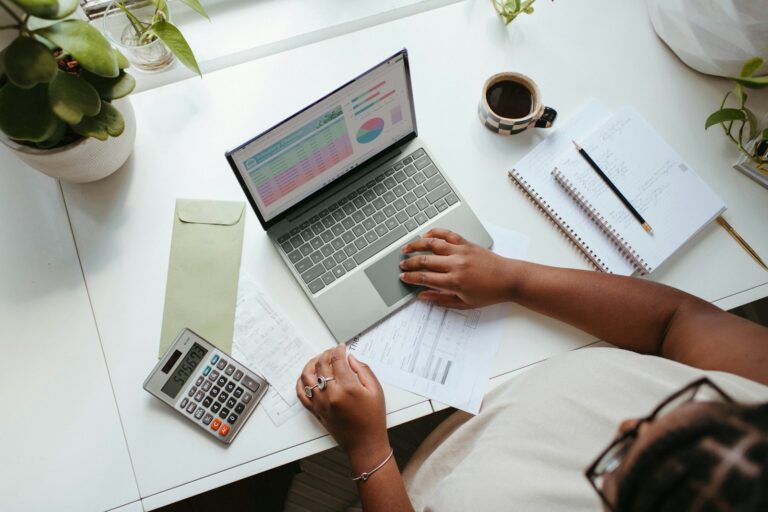 a person sitting at a table with a laptop; financial planning