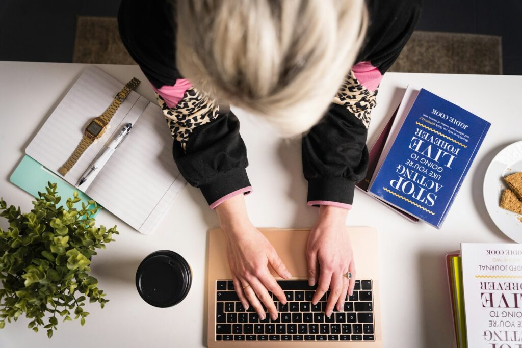 woman in black and pink long sleeve shirt using macbook pro; affiliate marketing career